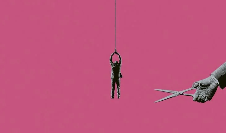 a man dangling from a rope that's about to be cut