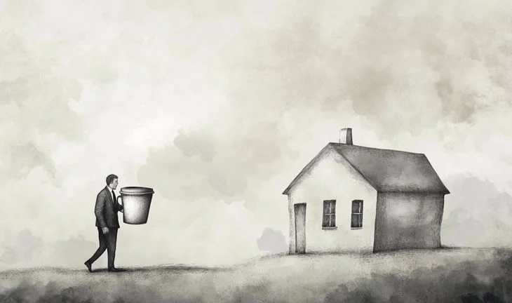 a banker holding coffee walking to a house