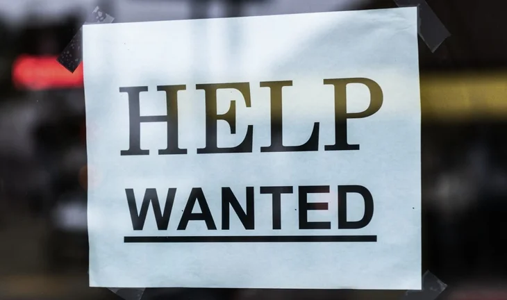 a sign that says help wanted 