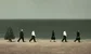 bankers walking on a beach by a Christmas tree